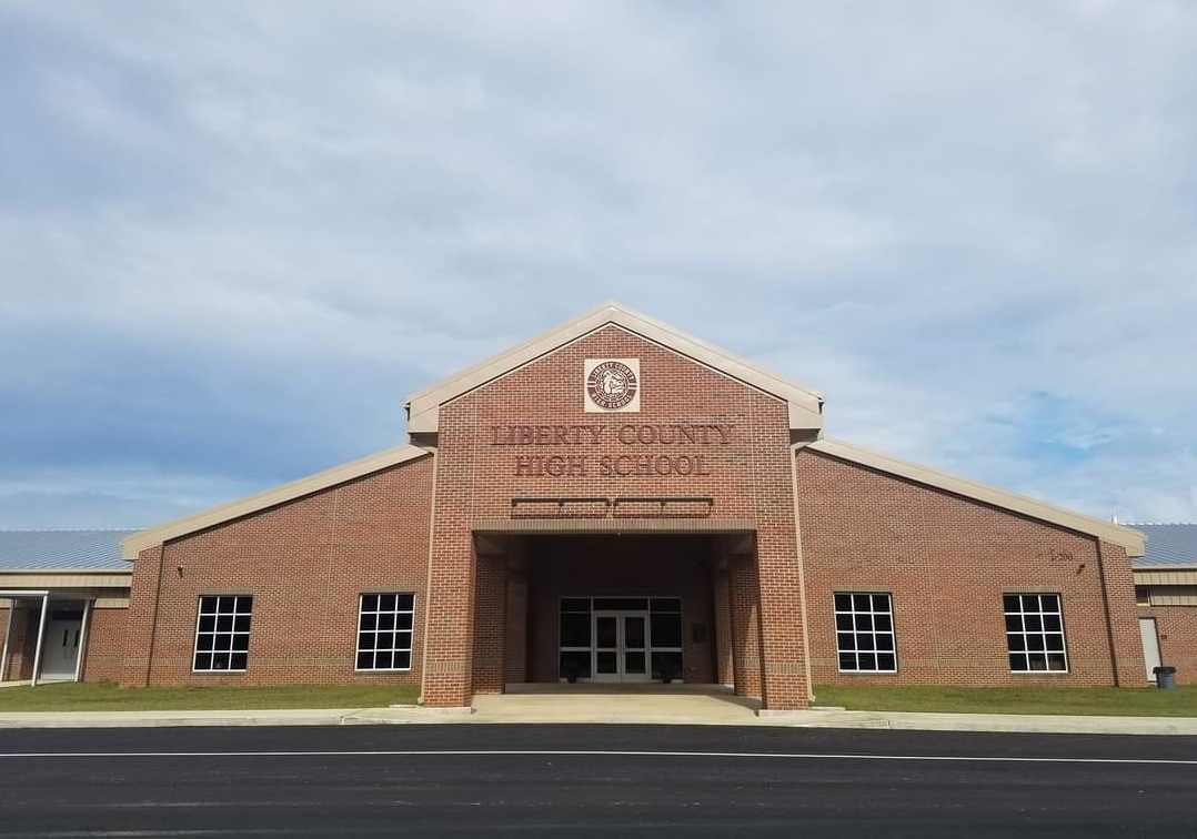The exterior of Liberty County High School, a brick building with a large entrance.