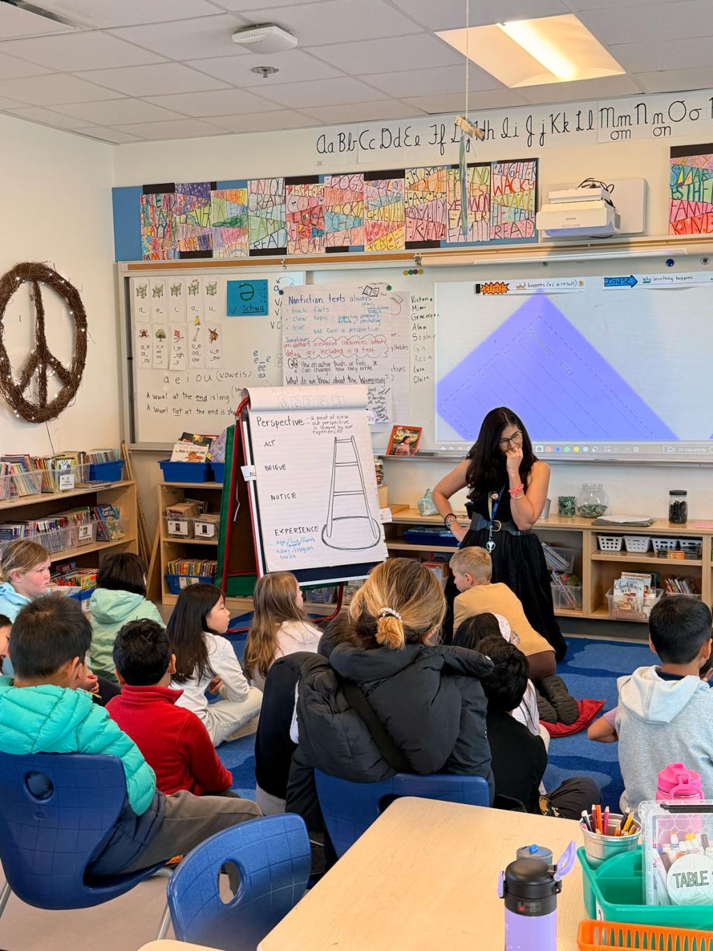A teacher presents a lesson to a classroom of attentive students.