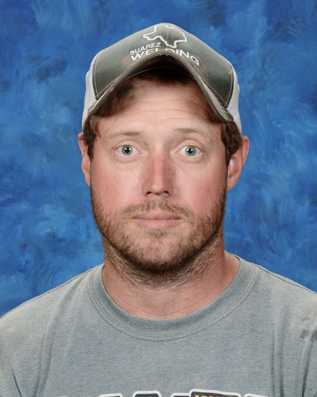 A man with reddish-brown hair and a beard looks directly at the camera.