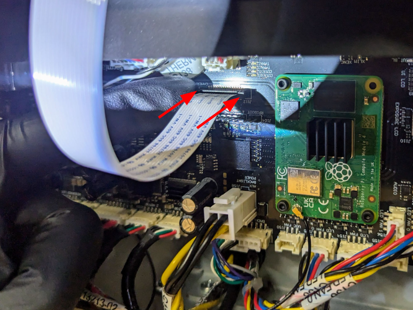 Slide the camera board ribbon cable into the connector.