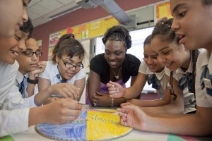 Teacher and kids around a school project