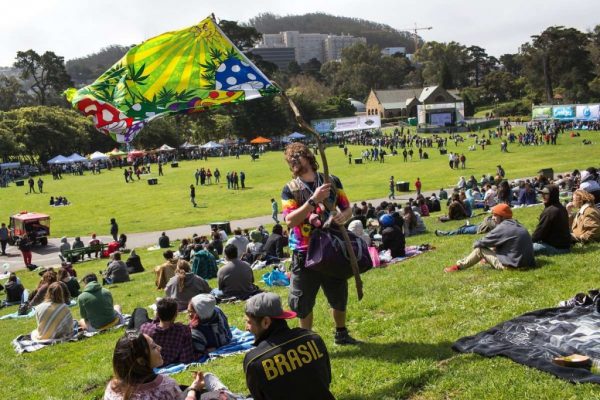 Kelly Jensen holds a flag while he makes his way through the crowd offering goods for sale during the annual 420 in the Park pot festival at Hippie Hill in Golden Gate Park. Saturday, April 20, 2019. San Francisco, Calif.Photo: Jana Asenbrennerova / Special to The Chronicle