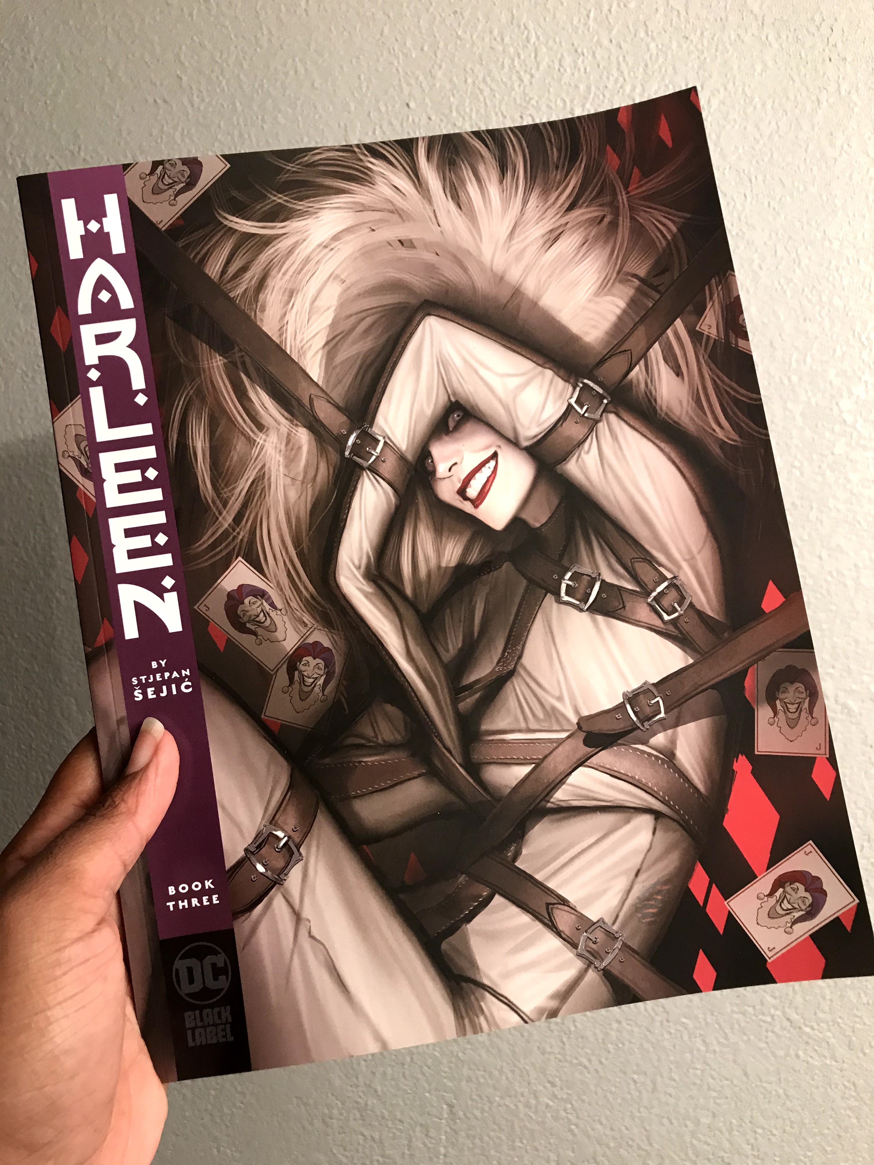 a hand holding an issue of Harleen from DC Black Label 2020
