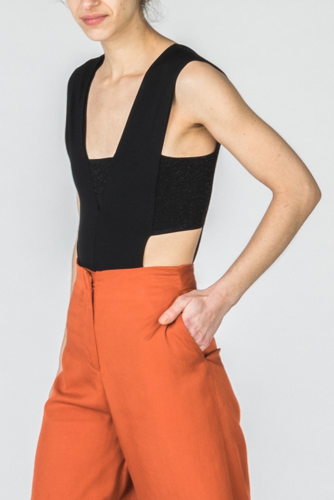 Hyena black top and orange trousers