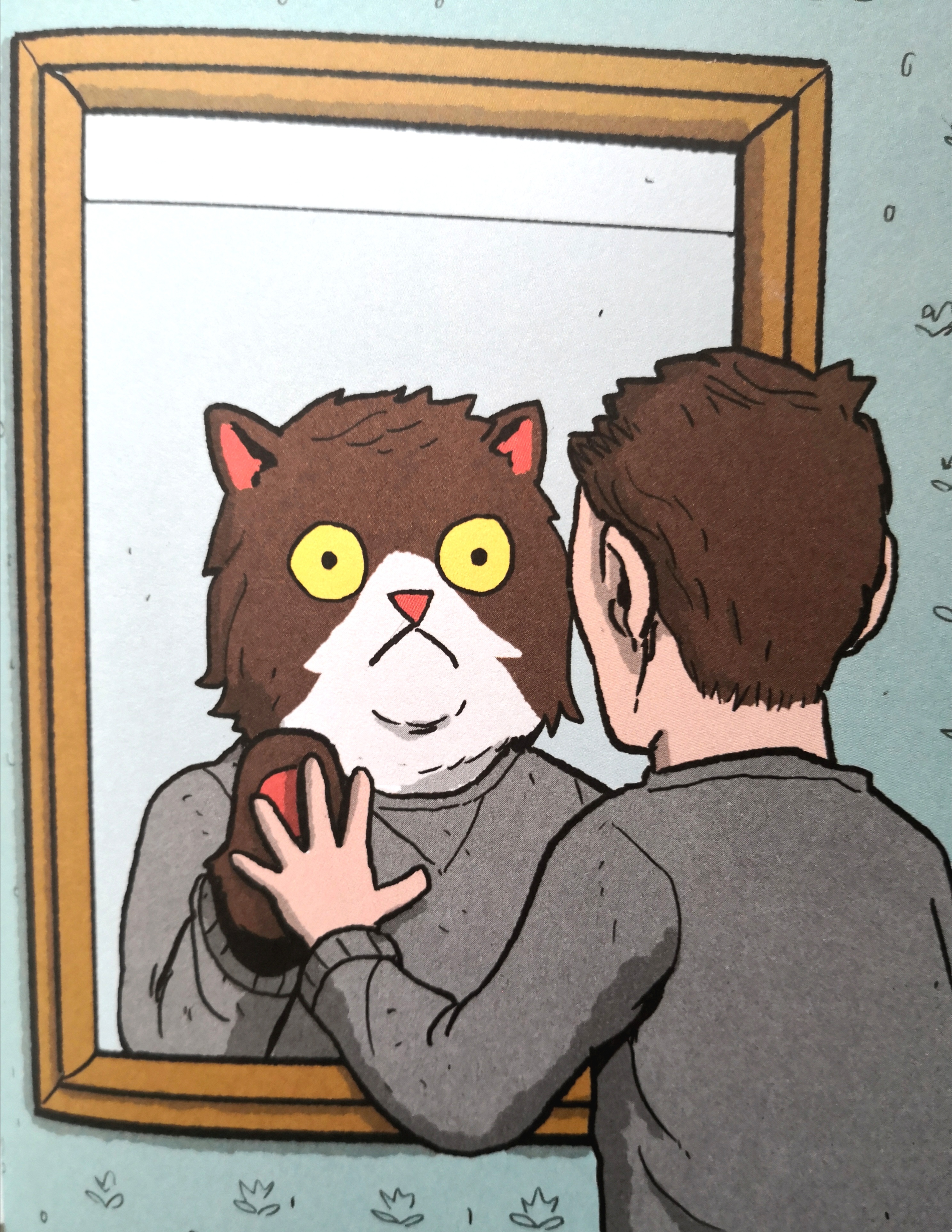 Man looking at his cat reflection in the mirror