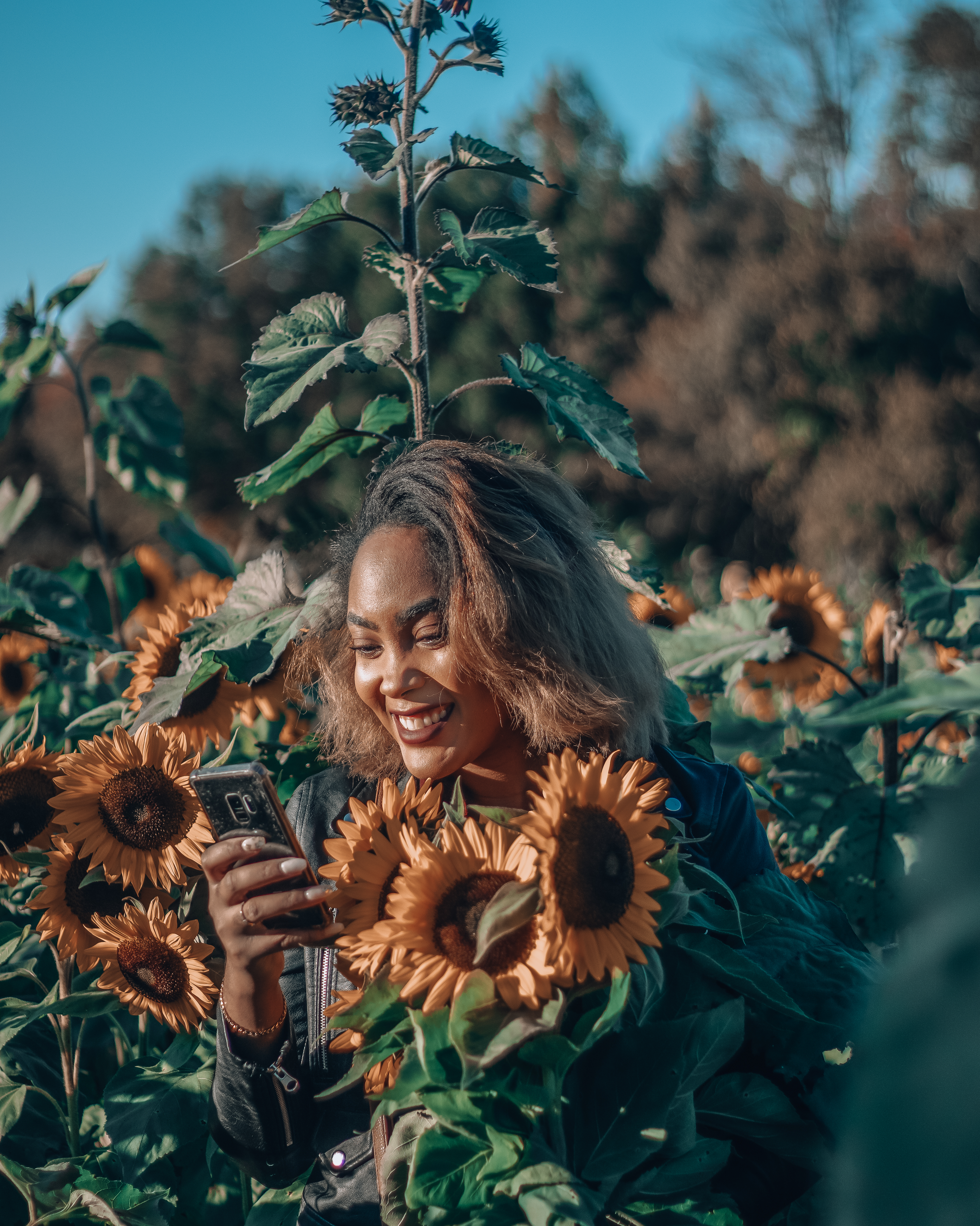 Girl smiling with sunflowers