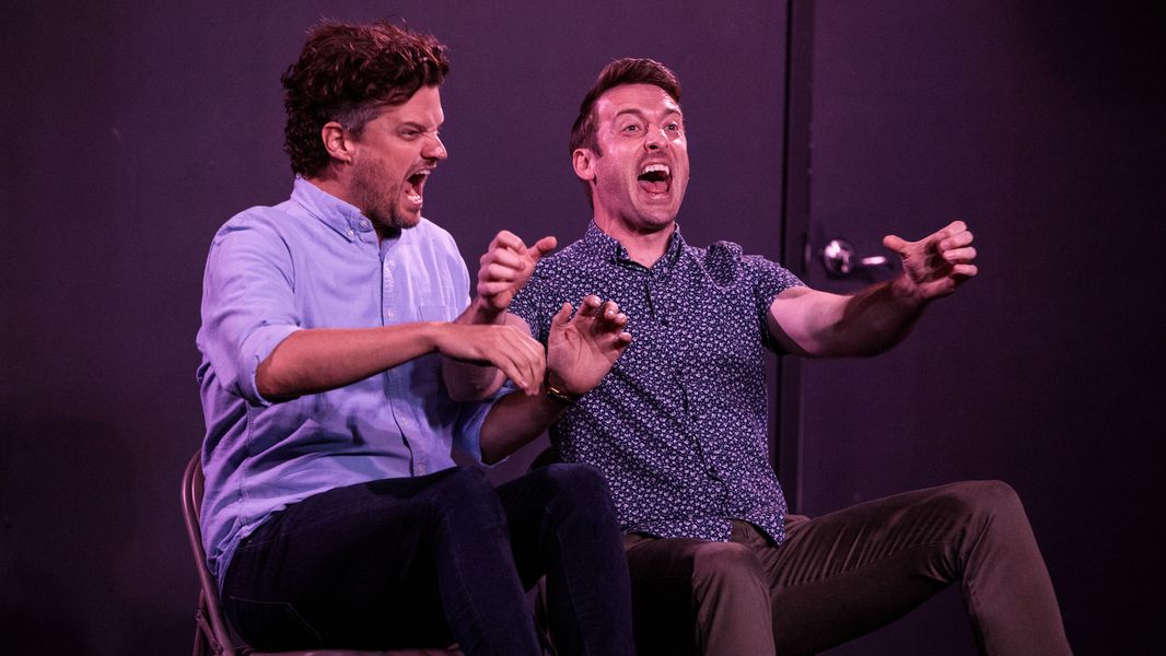 Two improvisers acting out a scene on stage