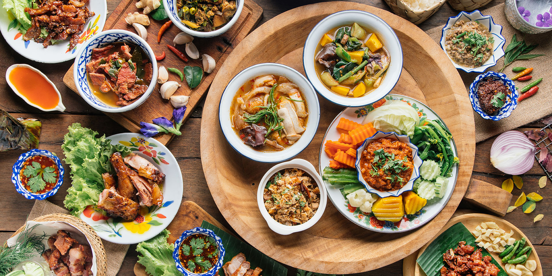 Spread of various Thai food in different size dishes
