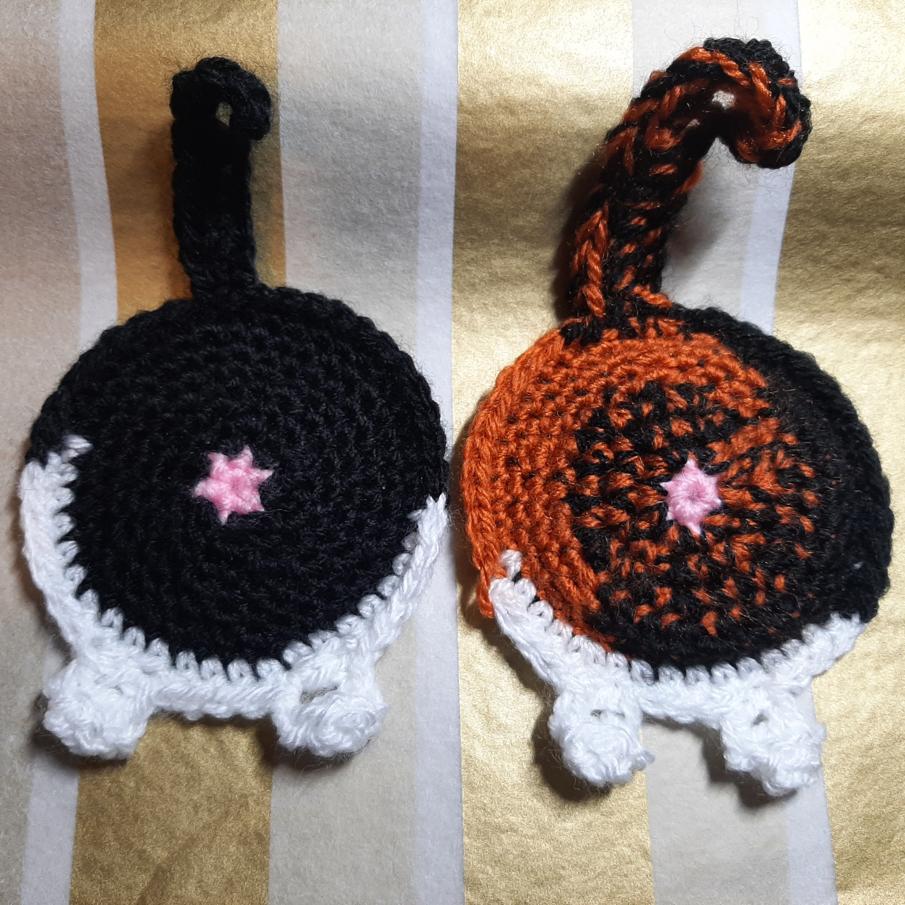 Two crocheted coasters in the shape of cat butts