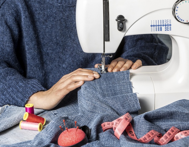 hands at sewing machine