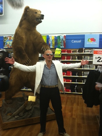 Pitbull standing next to a bear statue at a walmart