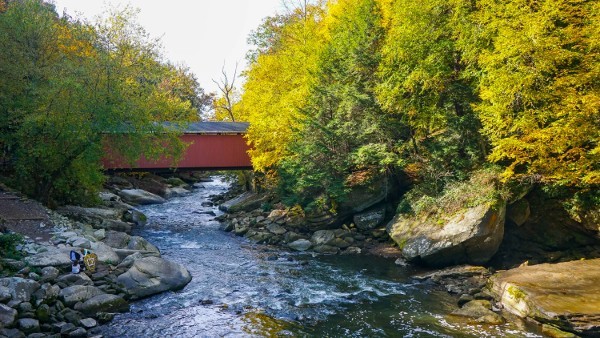 red covered bridge across river