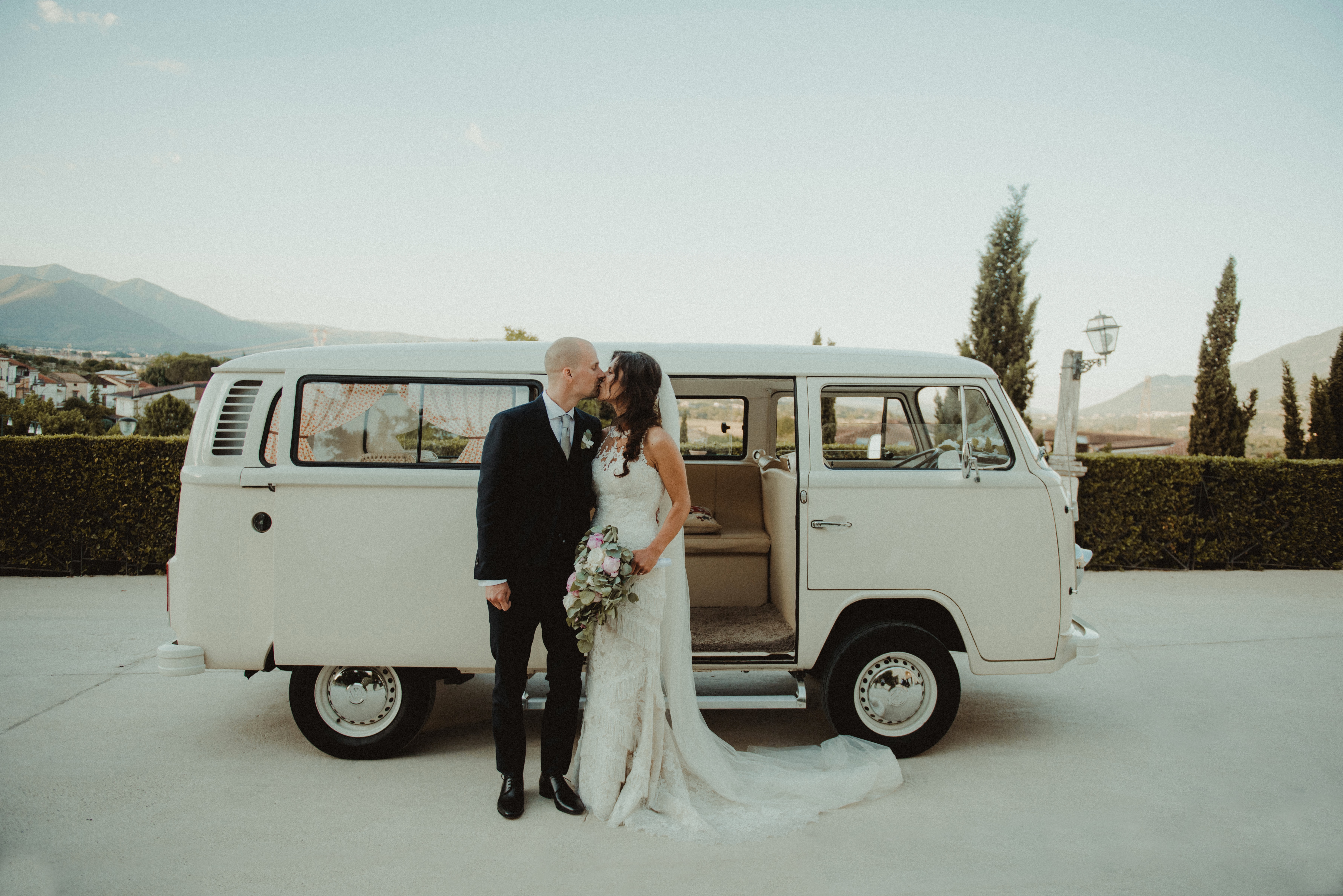 photo of wedding couple with van