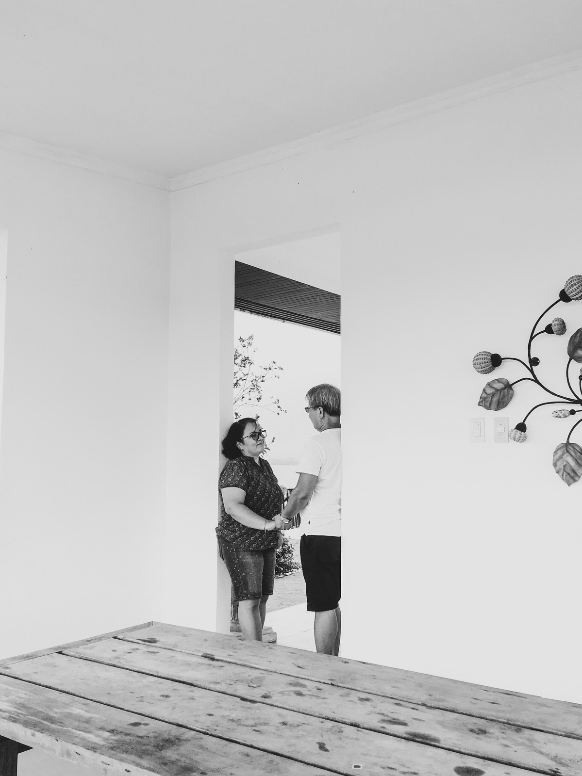 black and white photo with a couple looking at each other