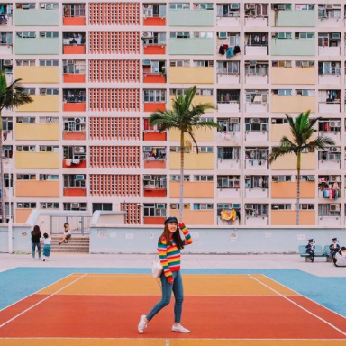 Girl walking with building in the backrgound