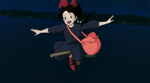 Girl in dark dress flying on broom
       with a black cat on her shoulder