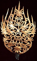 a gold pendant resembling a lotus flower