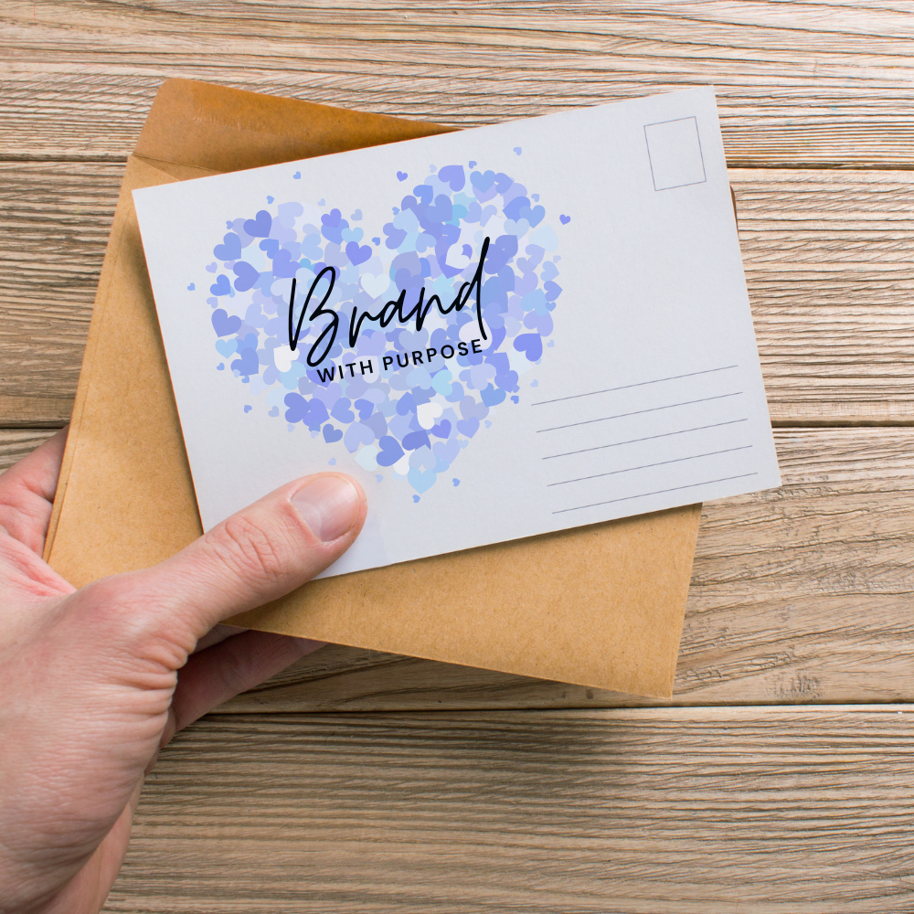 An image of someone holding a postacard and envelope.