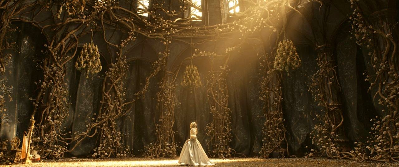 A woman standing in a sunlit ballroom--its walls lined with flowers