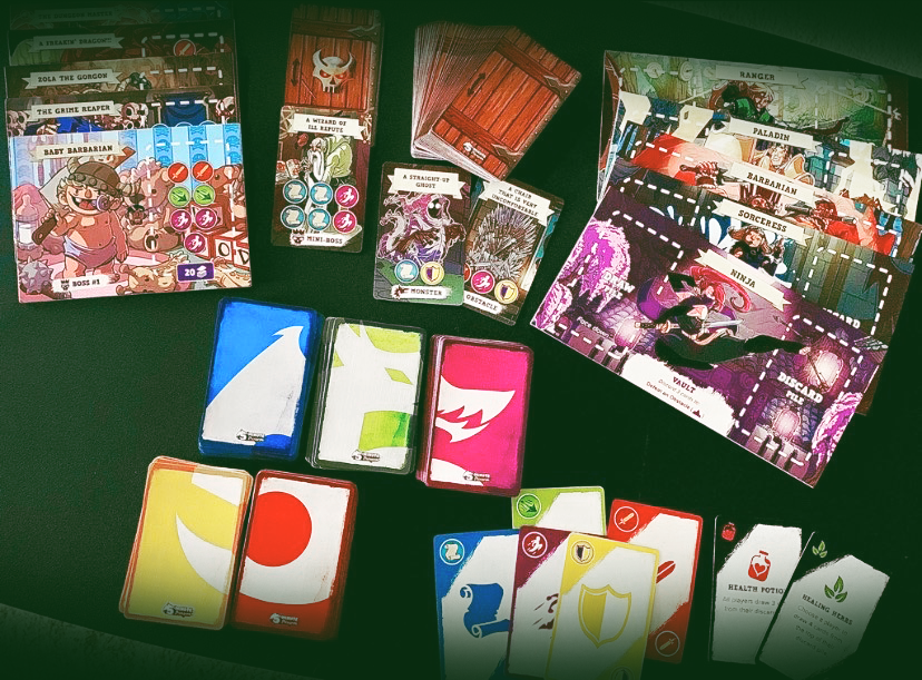 board game cards laid face up and face down, there are character cards, ability cards, and dungeon cards