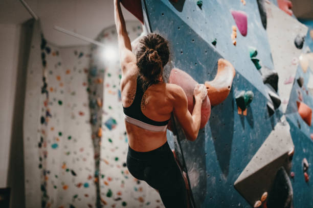 Woman bouldering on arete