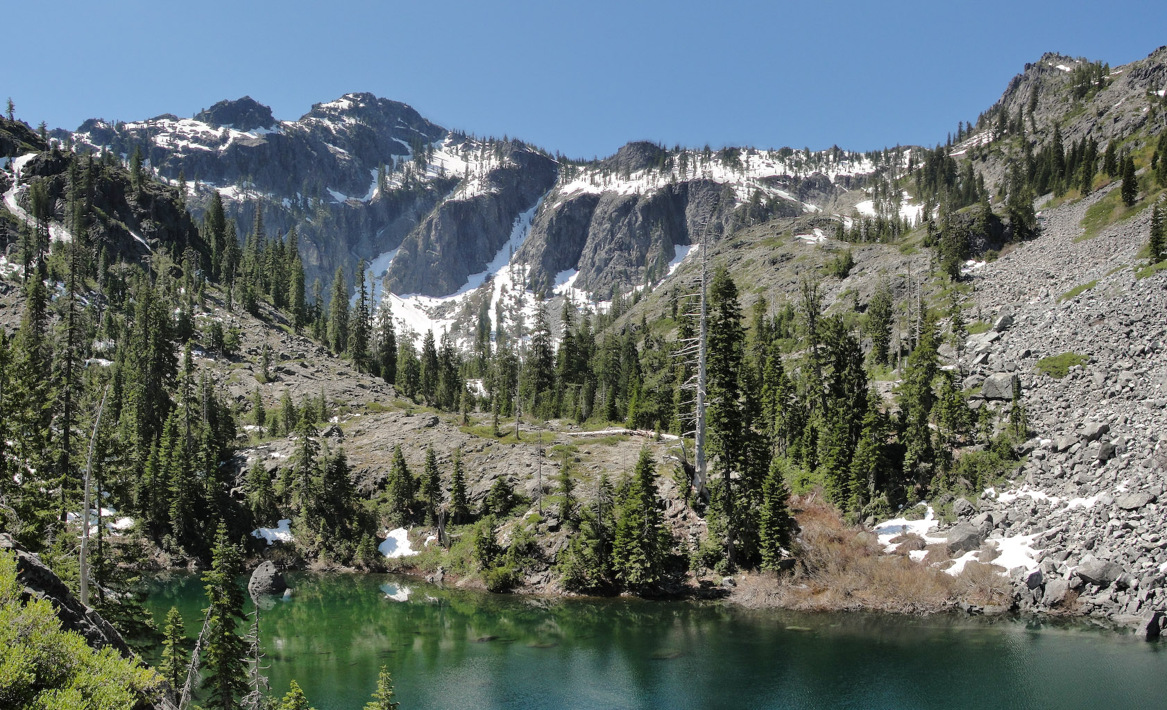 Lake with remaining snow on mountians in background