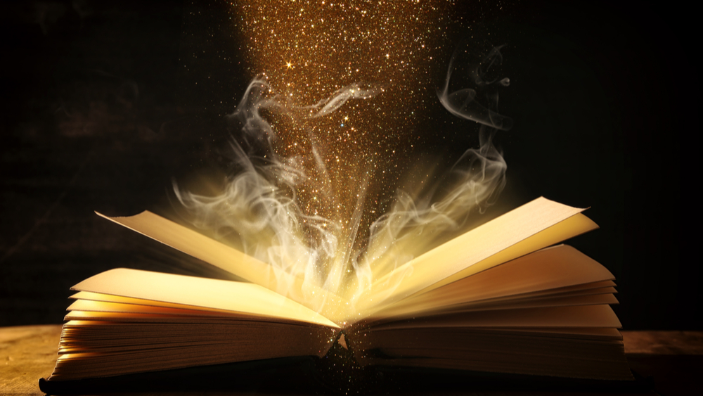Open book with magical dust floating above it