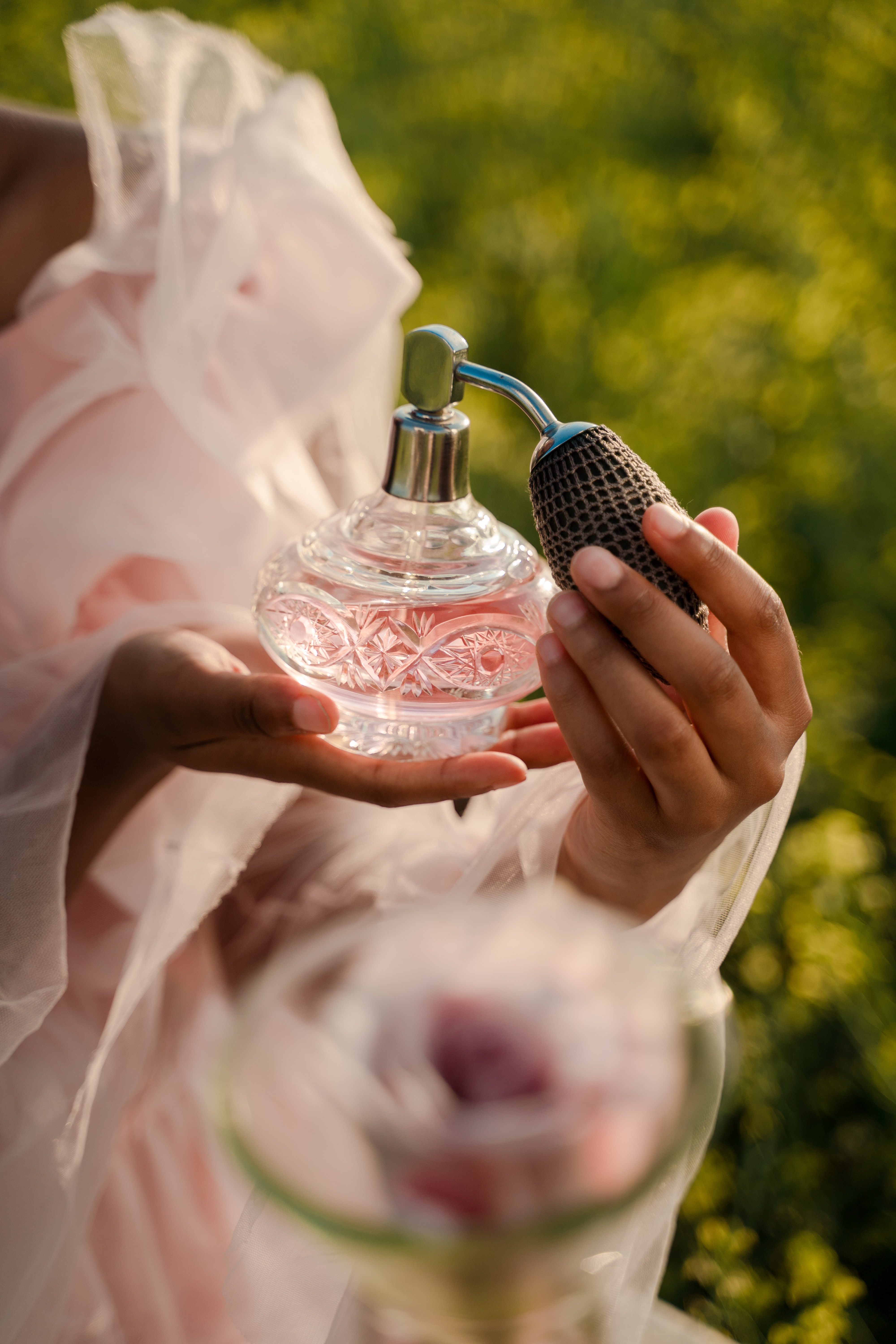 Woman holding vintage perfume bottle