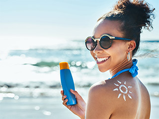 Woman applying sun cream