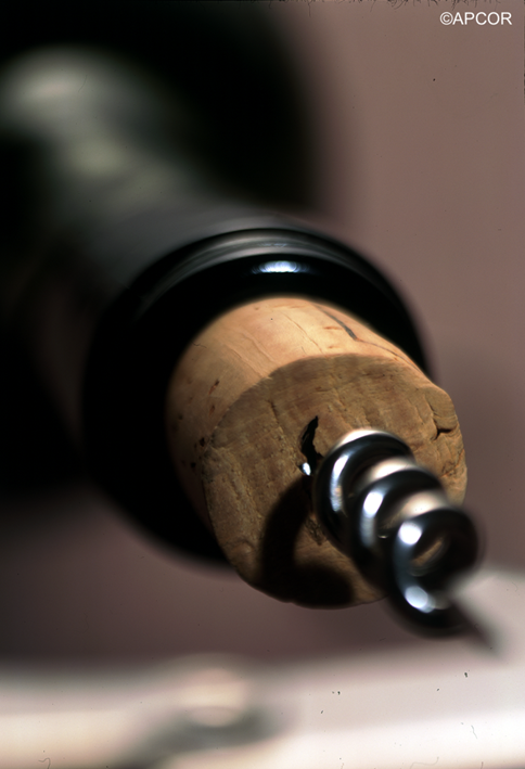 wine bottle with cork stopper being extracted