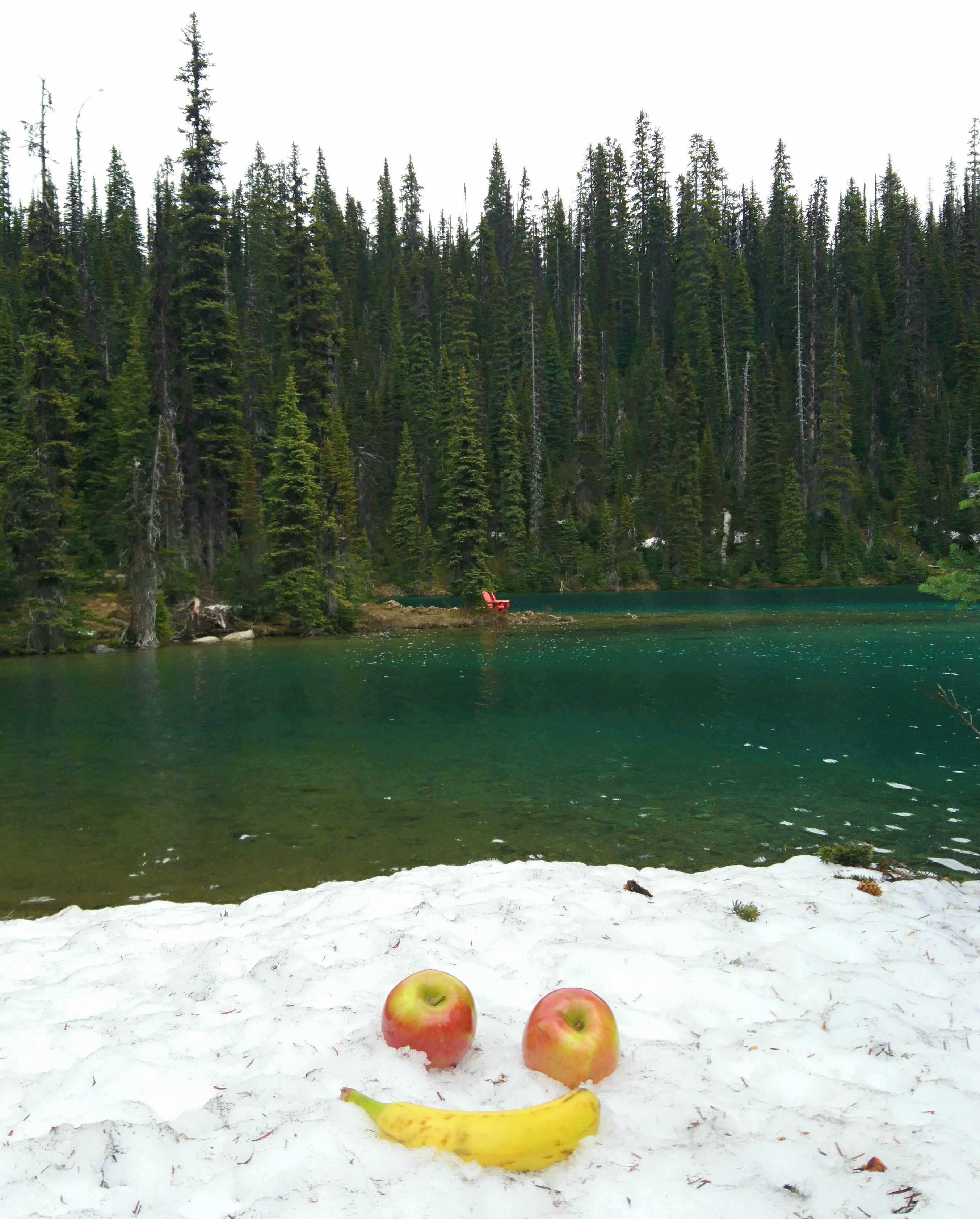apples and bananas at a snowy mountain lake