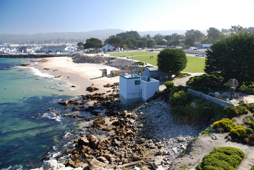 View of a rocky beach along the bright blue ocean water