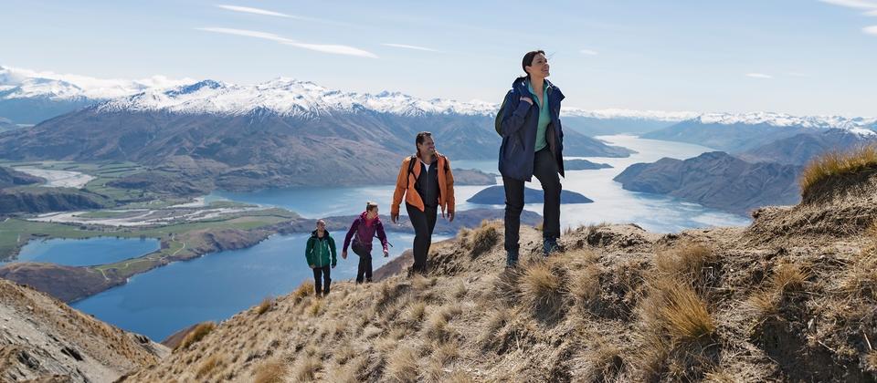 hiking people on a top of a hill