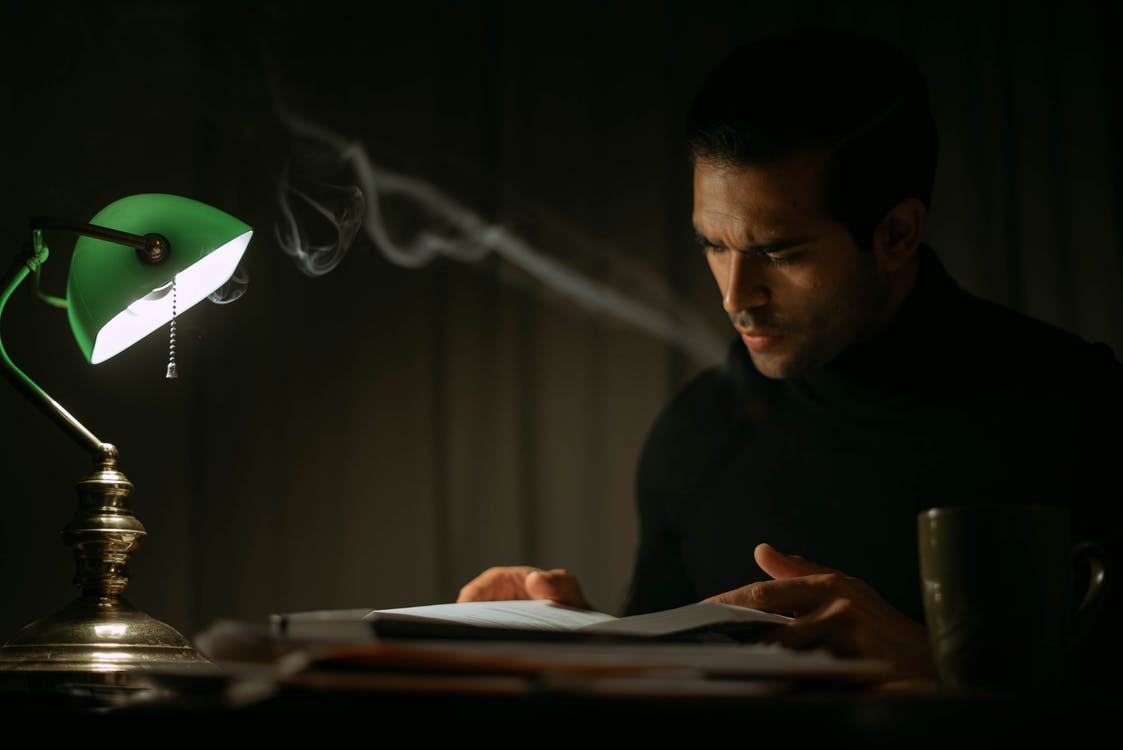 man reading by lamp