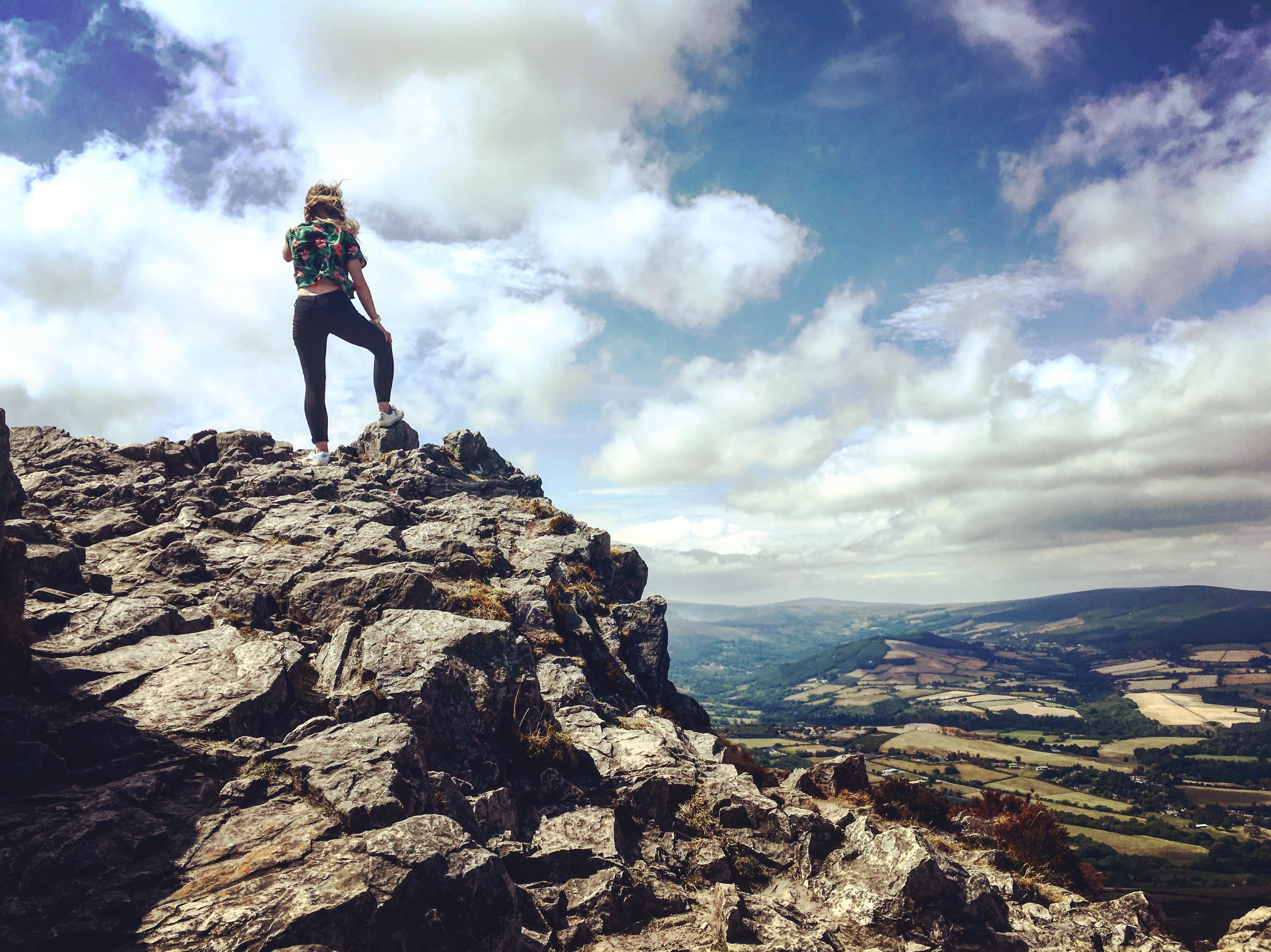girl standing at summit of mountain
