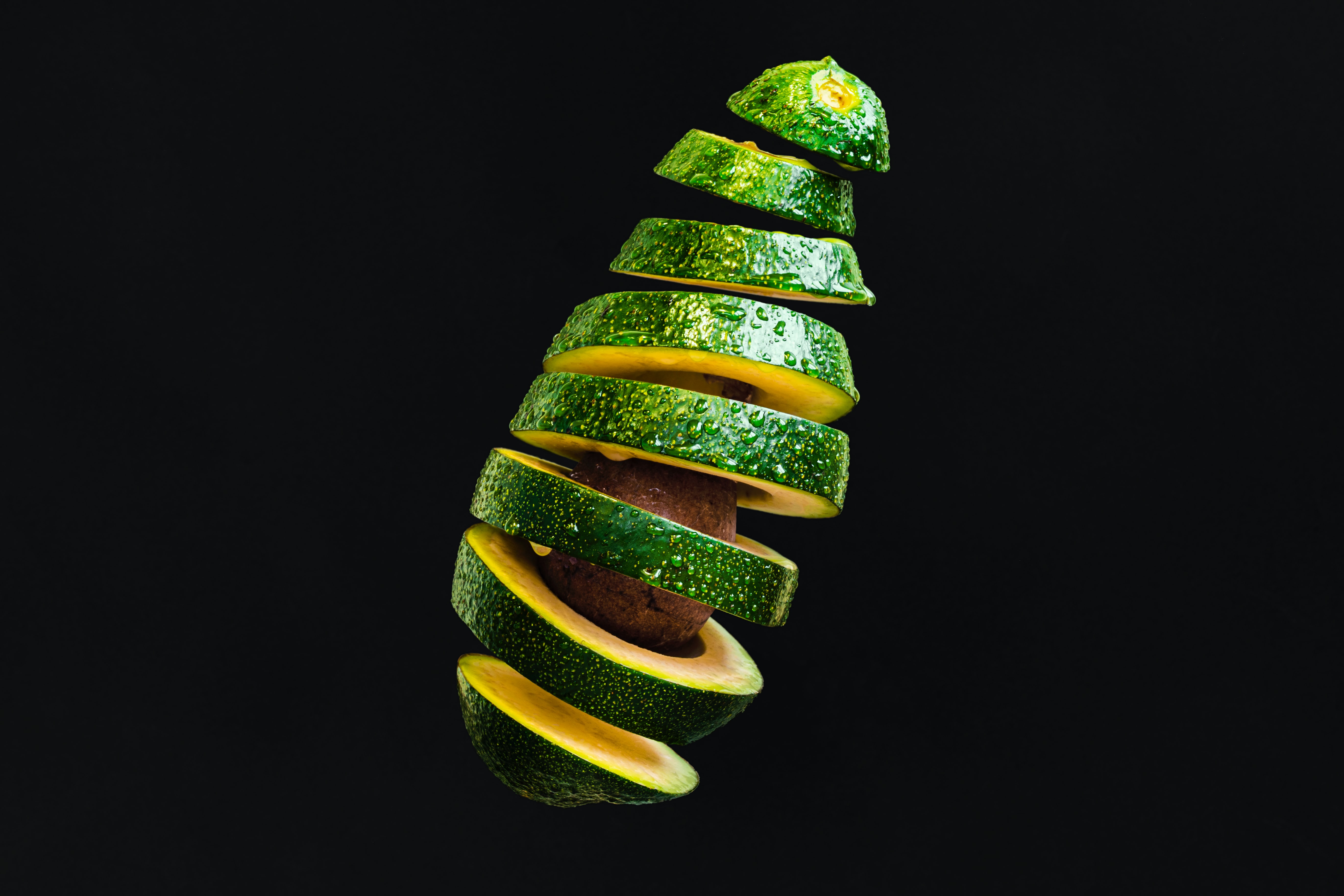 Image of avocado in chopped rings with black background