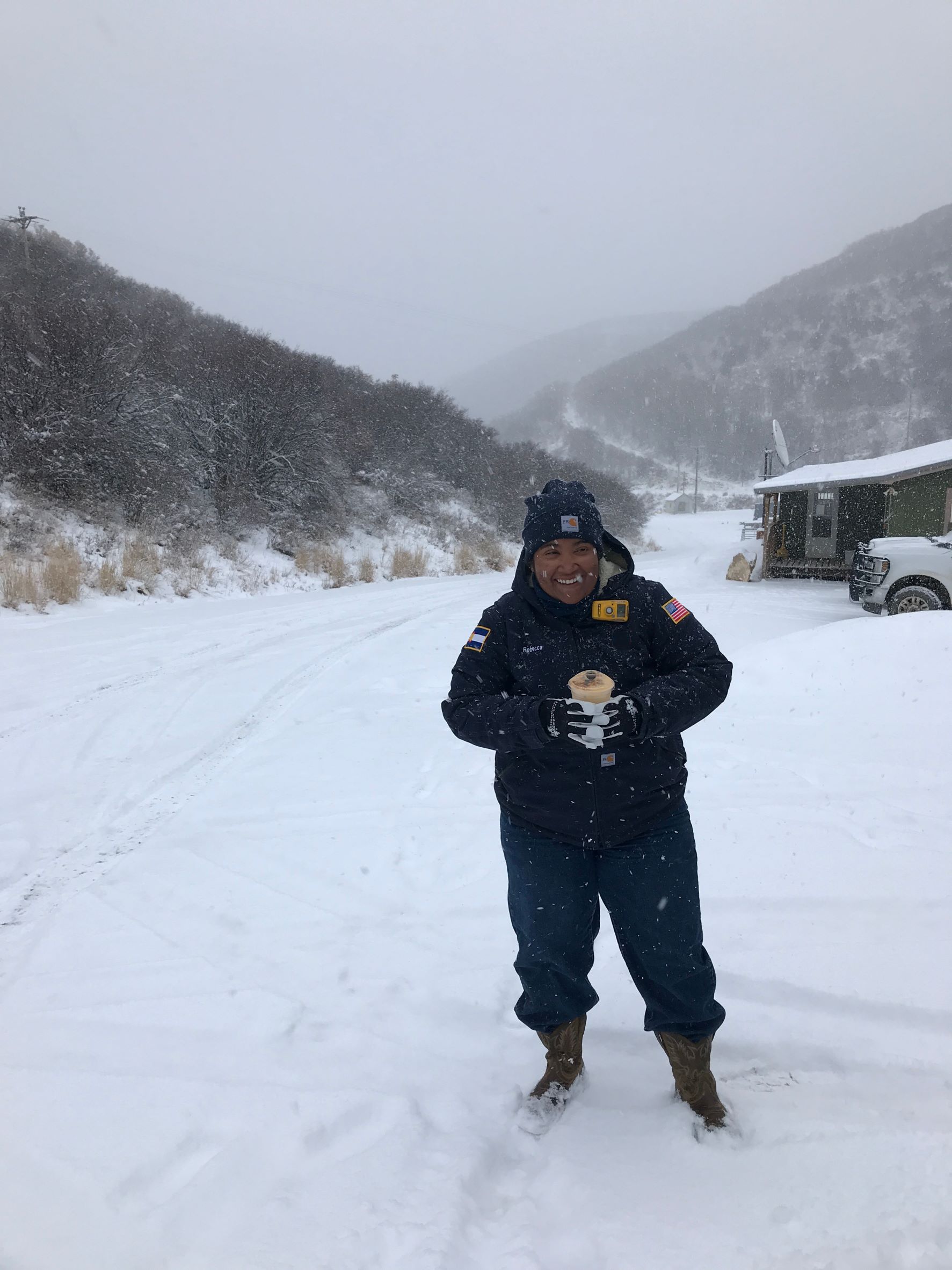 Rebecca in deep snow outside a jobsite in Colorado
