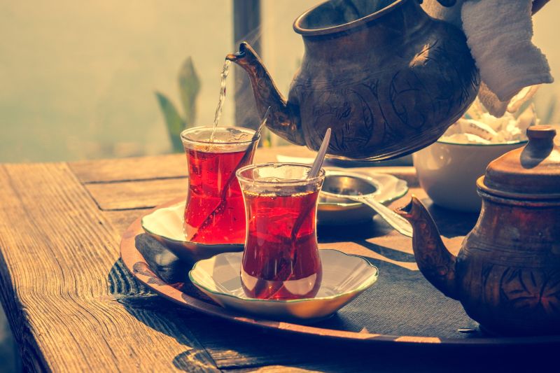 Tea being poured into two glasses