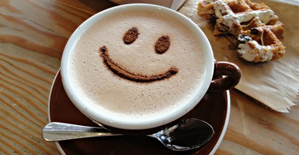 Coffee in a cup with a happy face in it
