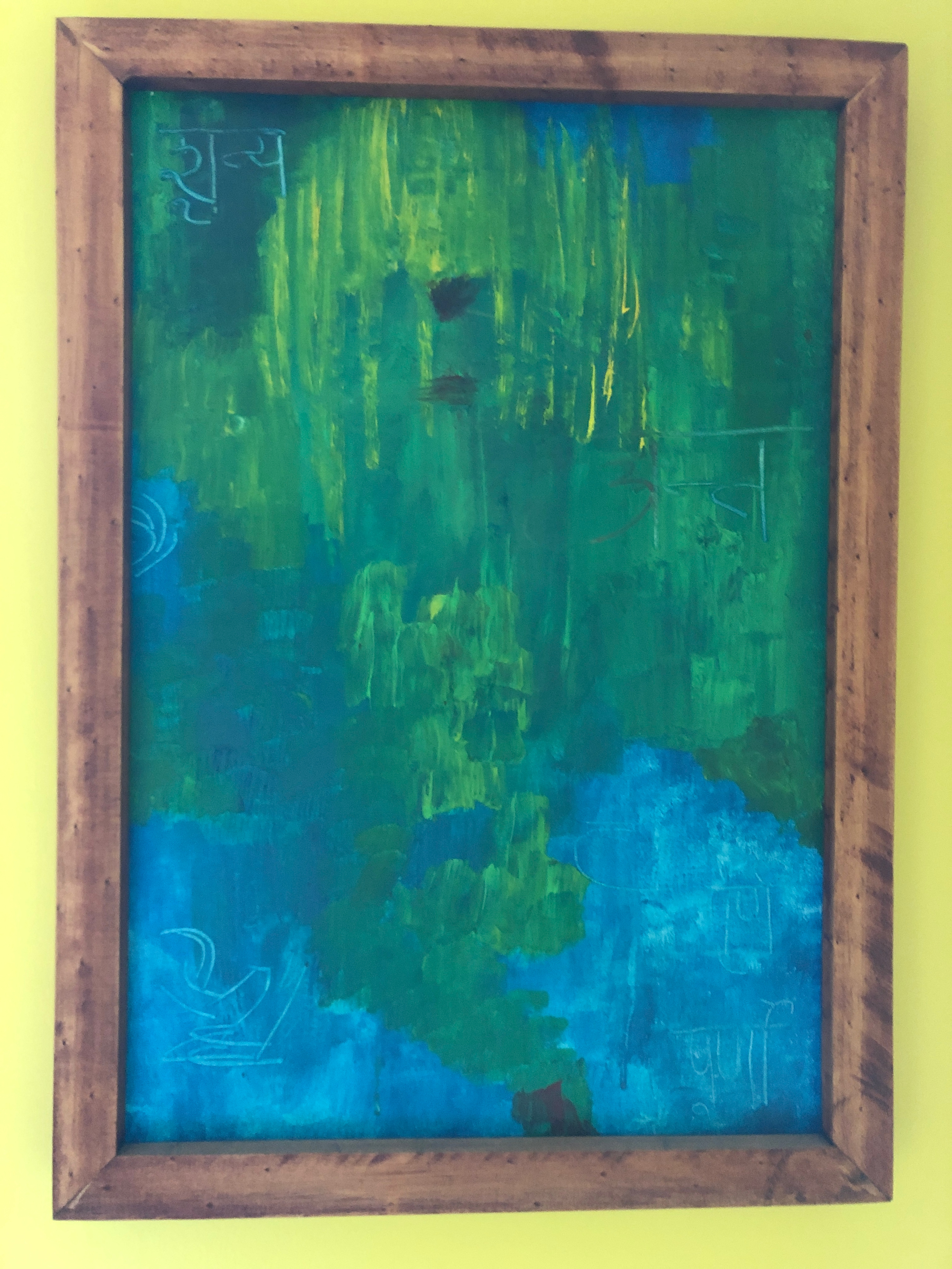 Close up image of an abstract painting with a greenish blue color palette
