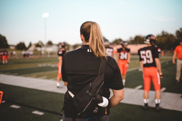 Female Athletic Trainer on Sidelines of American Football game