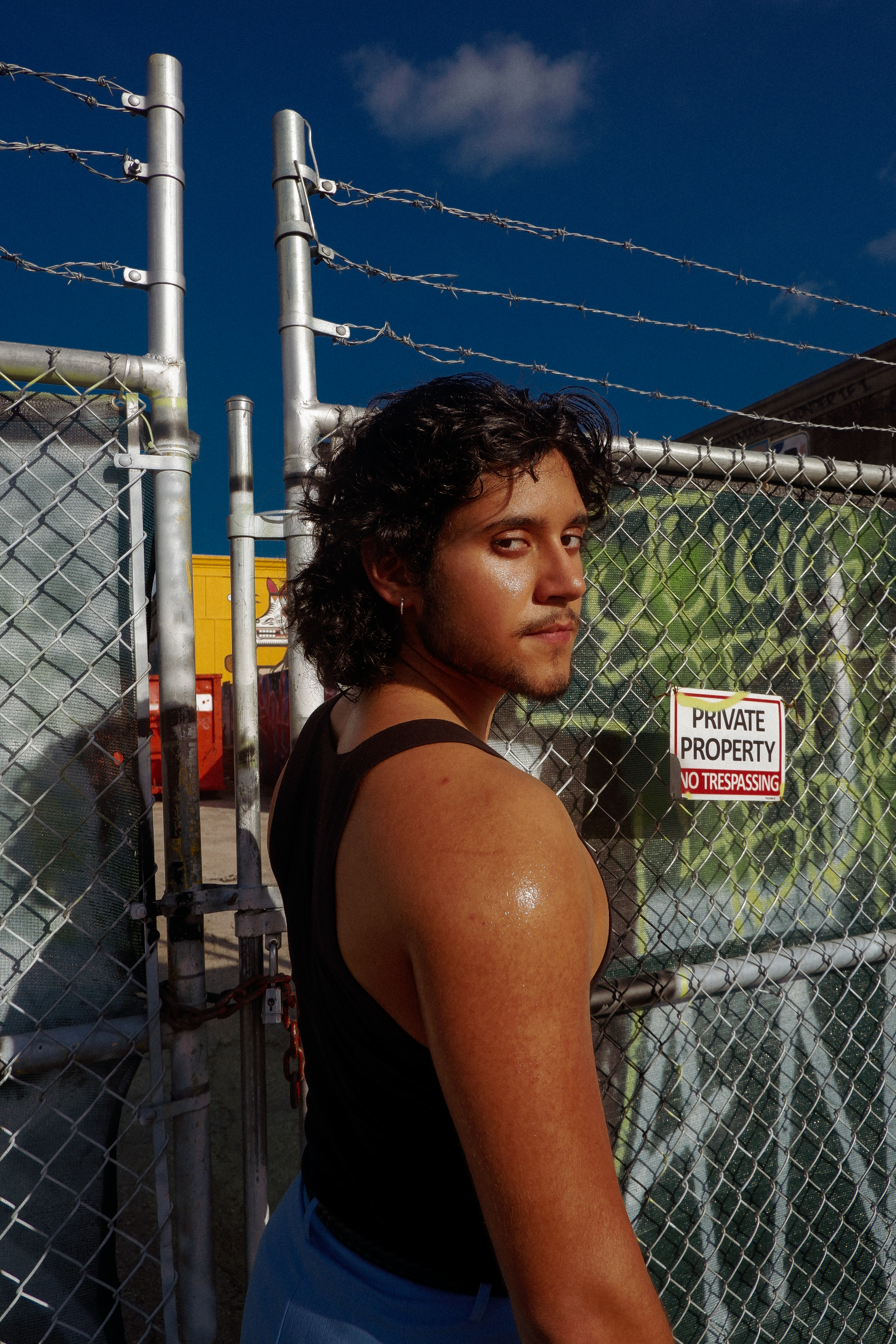 Photograph of man in muscle shirt