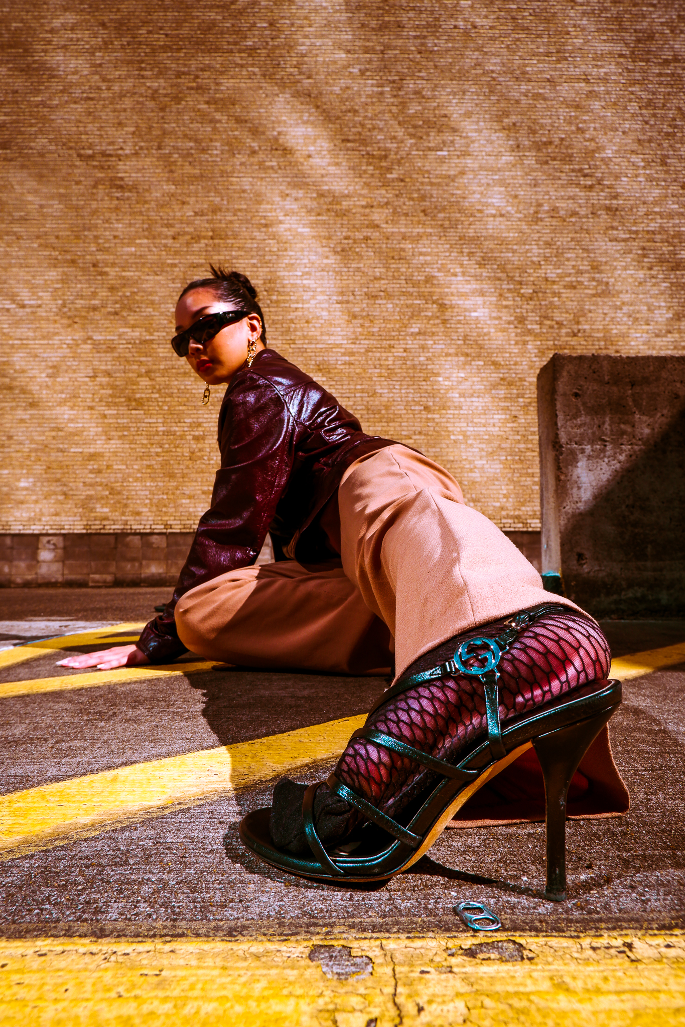 Photograph of woman at a low angle, her heel taking up the foreground