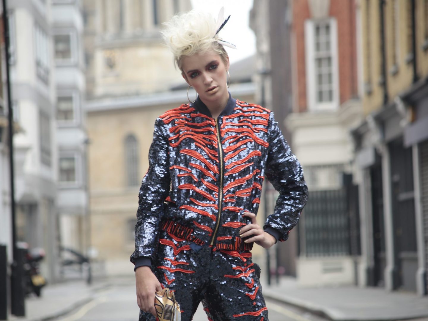 Model wearing jacket and trousers covered in tambour embroidery