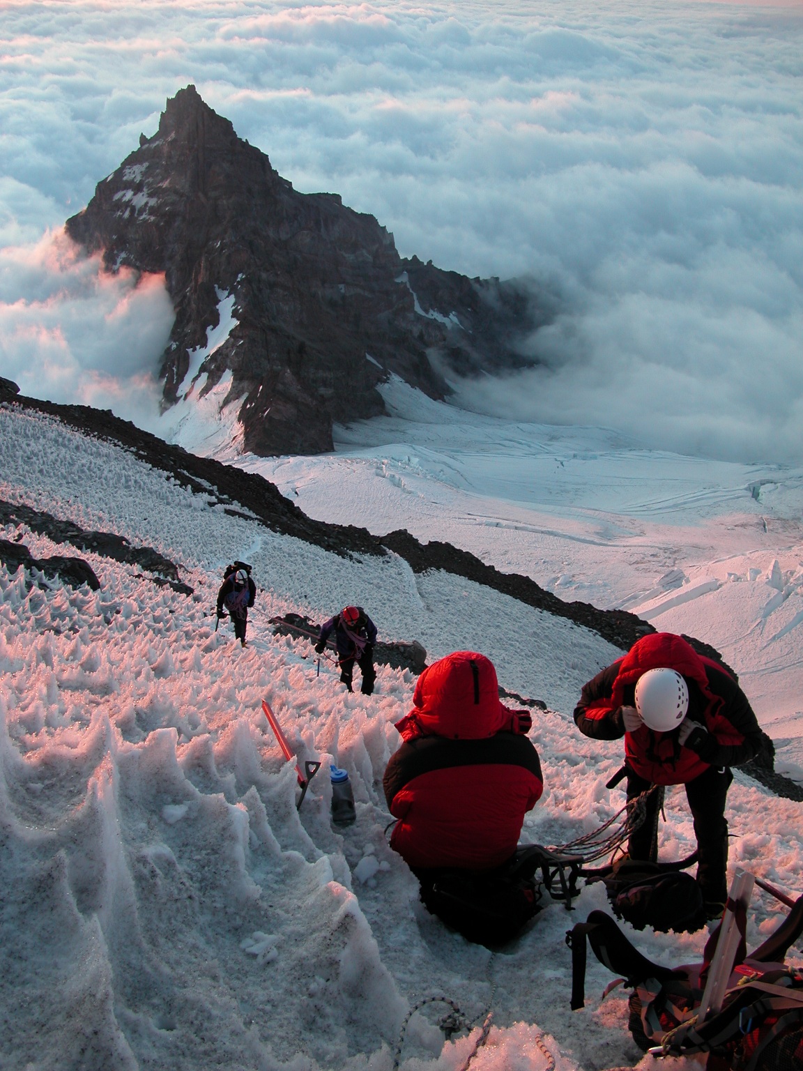 mountaineers climbing a glacier