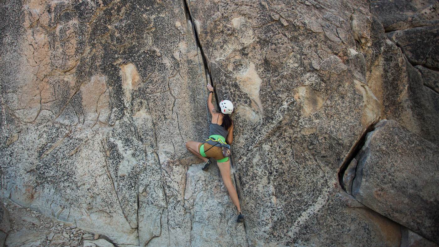 a woman rock climbing outside