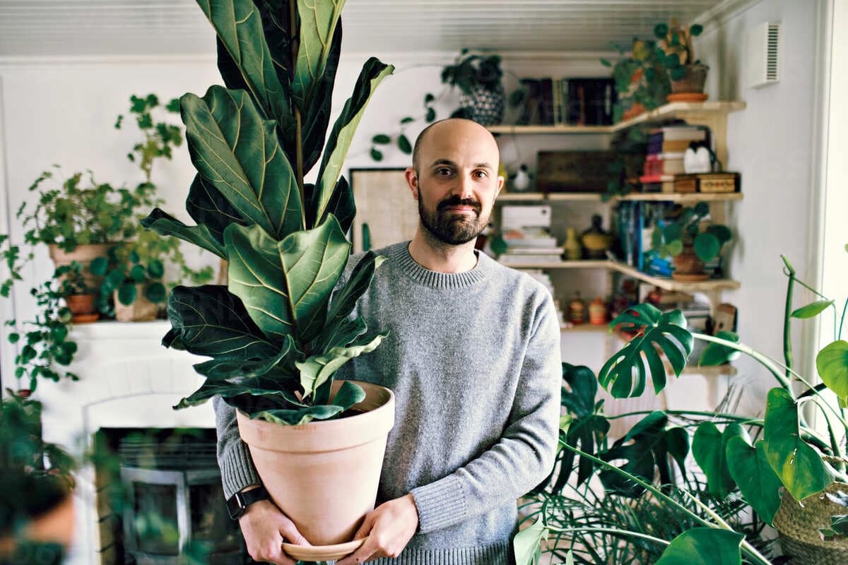 happy man with indoor plants