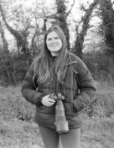 Photograph of Gini holding a camera