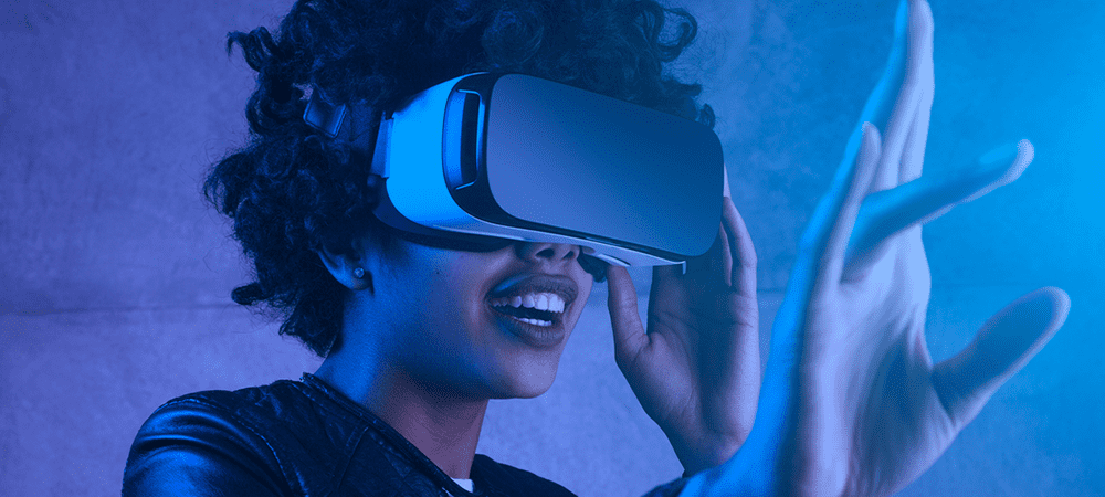 person wearing a VR headset with hand out strecthed