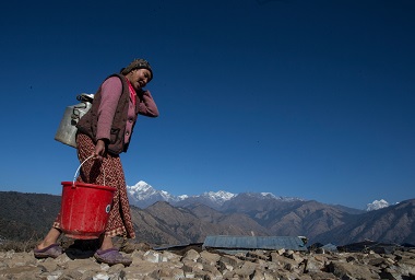 woman carrying jug of water